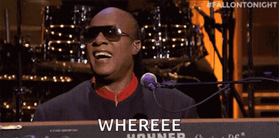 A Man Wearing Sunglasses Is Singing Into A Microphone While Playing A Keyboard That Says Whereee Hohner GIF