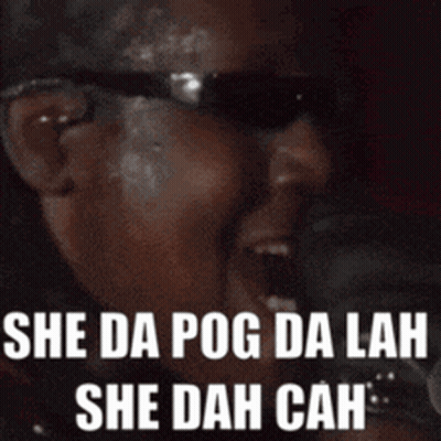 A Man Wearing Sunglasses Is Singing Into A Microphone With The Words She Da Pog Da Lah She Dah Cah . GIF