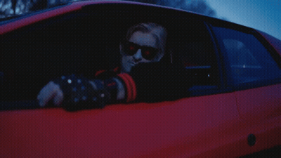 A Man Wearing Sunglasses Is Sitting In A Car GIF