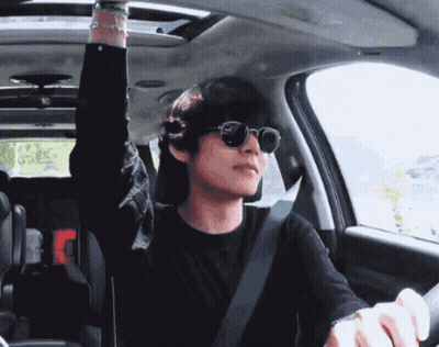 A Man Wearing Sunglasses Is Sitting In A Car GIF