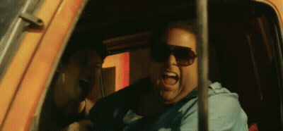 A Man Wearing Sunglasses Is Sitting In A Car And Screaming . GIF