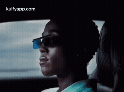 A Man Wearing Sunglasses Is Sitting In A Car . GIF