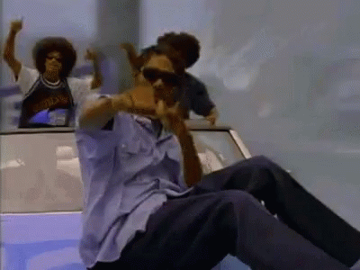 A Man Wearing Sunglasses Is Sitting In The Back Of A Car With Two Other Men GIF