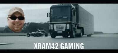 A Man Wearing Sunglasses Is Smiling In Front Of A Large Truck That Says Xram42 Gaming GIF