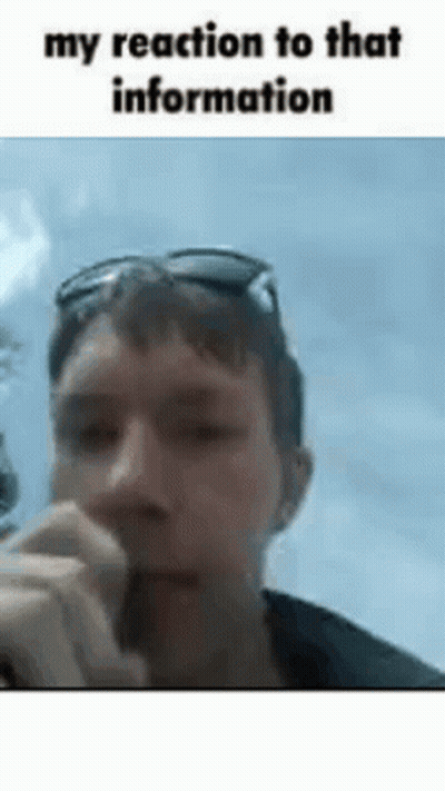A Man Wearing Sunglasses Is Smoking A Cigarette In A Gif . GIF