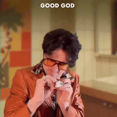 A Man Wearing Sunglasses Is Smoking A Cigarette With The Words Good God Behind Him GIF