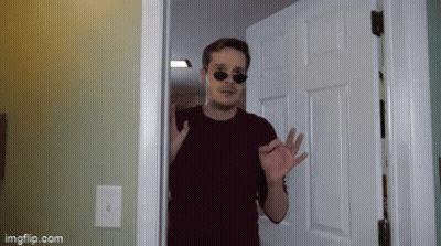 A Man Wearing Sunglasses Is Standing In A Doorway With Imgflip.com Written On The Bottom GIF