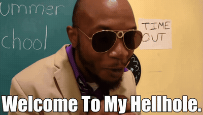 A Man Wearing Sunglasses Is Standing In Front Of A Chalkboard That Says Summer School GIF