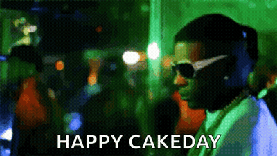 A Man Wearing Sunglasses Is Standing In Front Of A Crowd With The Words Happy Cakeday Written Below Him . GIF