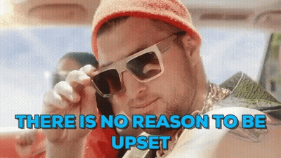 A Man Wearing Sunglasses Is Talking On A Cell Phone In A Car . GIF