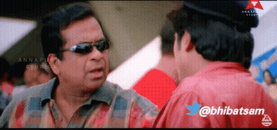 A Man Wearing Sunglasses Is Talking To Another Man With The Twitter Username @Bhibatsam GIF