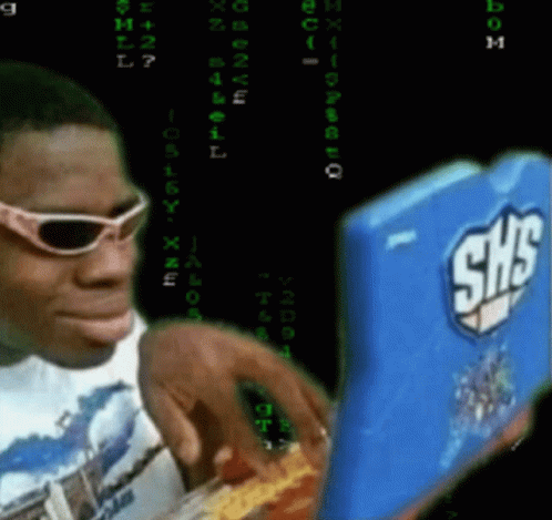 A Man Wearing Sunglasses Looks At A Shs Laptop GIF