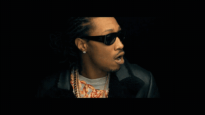 A Man Wearing Sunglasses Looks At The Camera GIF