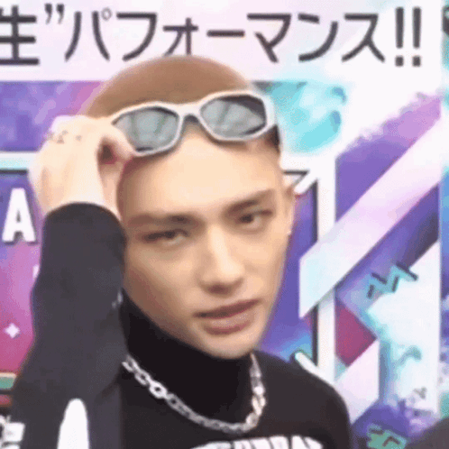 A Man Wearing Sunglasses On His Head Is Making A Face . GIF