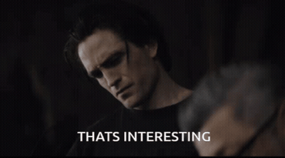 A Man Wearing Sunglasses Says Thats Interesting In A Dark Room GIF