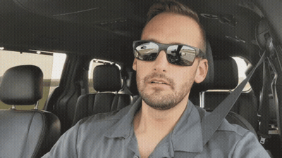 A Man Wearing Sunglasses Sits In A Car GIF
