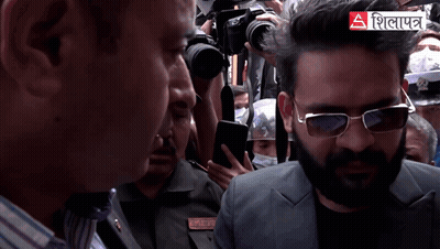 A Man Wearing Sunglasses Stands In A Crowd With A Sign That Says ' A ' GIF
