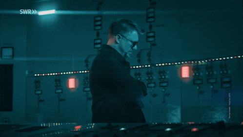 A Man Wearing Sunglasses Stands In Front Of A Screen That Says Hackerman GIF