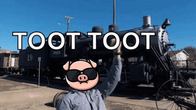 A Man Wearing Sunglasses Stands In Front Of A Train With The Words Toot Toot Written On It GIF