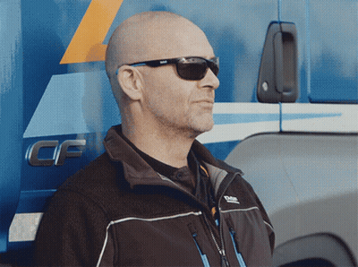A Man Wearing Sunglasses Stands In Front Of A Truck That Says Cf On The Side GIF
