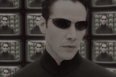 A Man Wearing Sunglasses Stands In Front Of A Wall Of Televisions With The Words The Problem Is Choice Below Him GIF