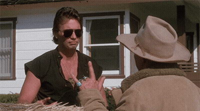 A Man Wearing Sunglasses Talks To Another Man In A Cowboy Hat GIF