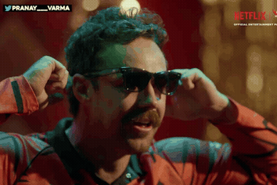A Man Wearing Sunglasses With A Netflix Logo On The Bottom Right GIF