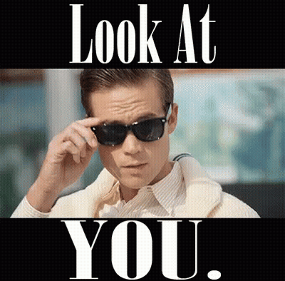 A Man Wearing Sunglasses With The Words Look At You Behind Him GIF
