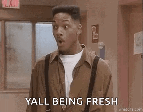 A Man Wearing Suspenders And A Brown Shirt Is Standing In A Hallway . GIF