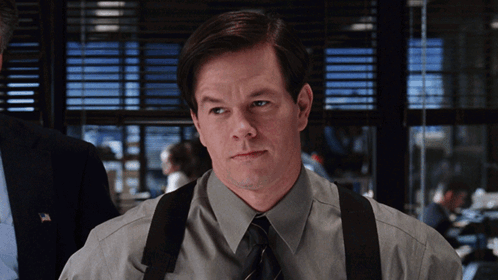 A Man Wearing Suspenders And A Tie Looks To His Left GIF
