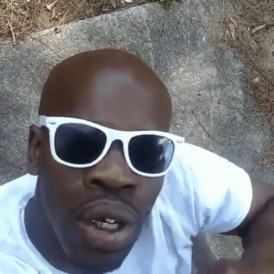 A Man Wearing White Sunglasses And A White Shirt GIF