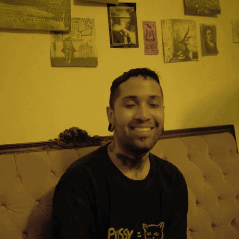 A Man Wears A Black Shirt That Says Pussy On It GIF