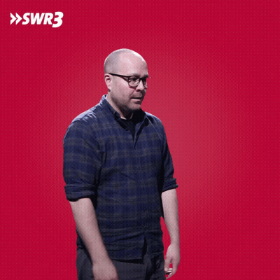 A Man Wipes His Eyes In Front Of A Red Background With The Letters Swr3 On It GIF