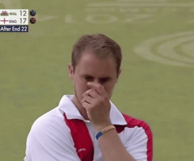 A Man Wipes His Nose In Front Of A Scoreboard That Says " After End 22 " GIF