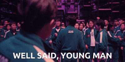 A Man With 226 On His Back Stands In Front Of A Crowd GIF