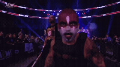 A Man With A Aew Logo On His Shirt GIF