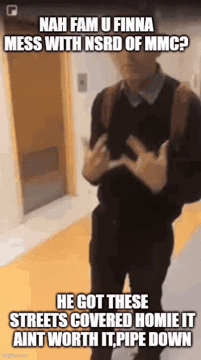 A Man With A Backpack Is Standing In A Hallway And Making A Funny Face GIF