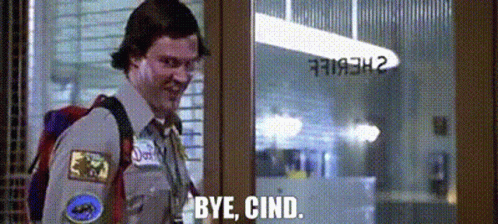 A Man With A Backpack Is Standing In Front Of A Glass Door And Saying `` Bye , Cind . '' GIF