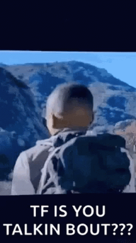Man With Backpack Standing In Front Of Mountain Talking GIF