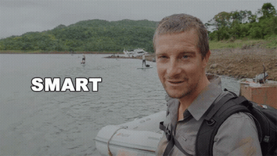 A Man With A Backpack Stands In Front Of A Body Of Water With The Word Smart Below Him GIF
