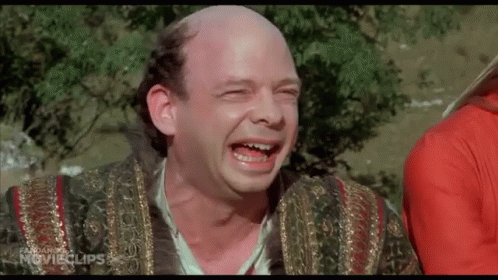A Man With A Bald Head Is Laughing With His Eyes Closed And His Mouth Open . GIF