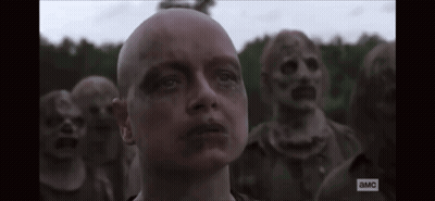 A Man With A Bald Head Is Standing In Front Of A Group Of Zombies With The Letters A And Mc On The Bottom GIF
