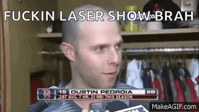 A Man With A Bald Head Is Talking To A Reporter In A Locker Room With The Words Fuckin Laser Show On The Bottom GIF