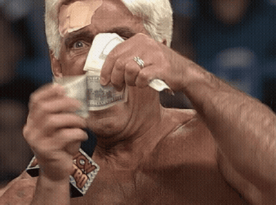 A Man With A Bandage On His Forehead Is Holding A Stack Of Money In Front Of His Face GIF
