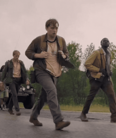 A Man With A Bandage On His Head Is Running Down The Road GIF