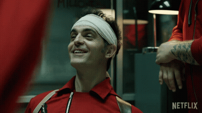 A Man With A Bandage On His Head Is Smiling In Front Of A Netflix Ad GIF