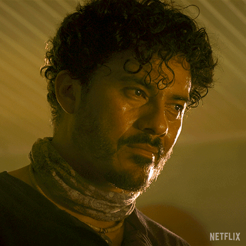 A Man With A Bandana Around His Neck And A Netflix Logo On The Bottom Right GIF