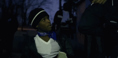 A Man With A Bandana Around His Neck Is Holding A Bunch Of Money GIF