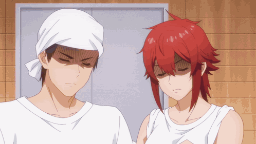 A Man With A Bandana On His Head And A Woman With Red Hair Standing Next To Each Other GIF