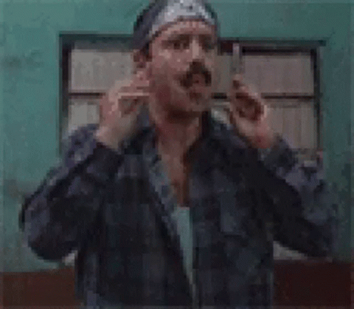 A Man With A Bandana On His Head Is Making A Funny Face And The Words Waas Sappen Are Above Him GIF